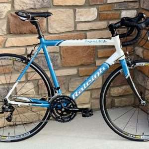 2004 Raleigh Capri (51cm). This women's-specific road bike features a lightweight aluminum frame and relaxed geometry, making it perfect for beginners and endurance enthusiasts.